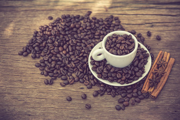 Coffee cup and coffee bean on a wooden table