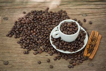 Coffee cup and coffee bean on a wooden table