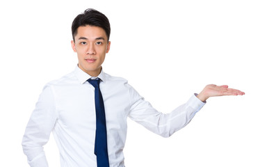 Young businessman with hand showing something