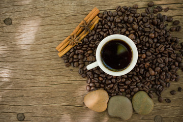 Coffee cup and coffee bean on a wooden table
