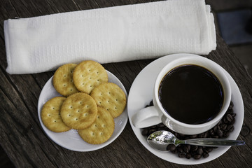 black coffee and coffee bean with biscuits