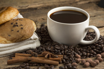 Coffee cup and coffee bean on a wooden table