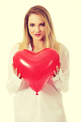 Young woman with heart shaped balloon.