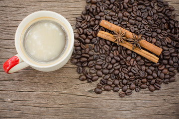 Coffee cup and coffee bean on a wooden table