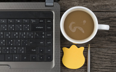 work office desk with a cup of coffee computer laptop, notebook,