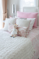 Fototapeta na wymiar kid's bedroom with doll on bed in pink color style