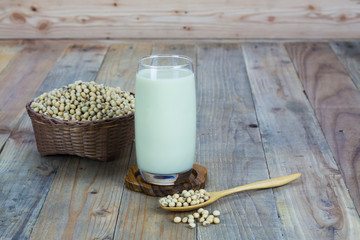Glass with Soy Milk and Seeds on wooden background