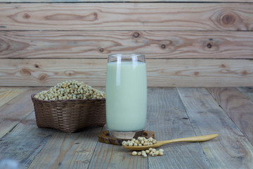 Glass with Soy Milk and Seeds on wooden background