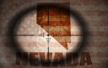 sniper scope aimed at the vintage american flag and nevada state map