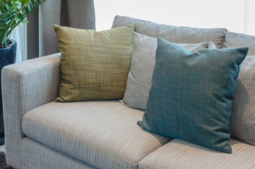 group of fabric pillows on fabric sofa in living room