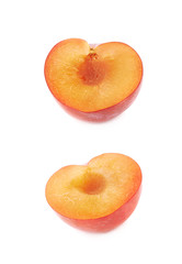 Cut open plum half isolated
