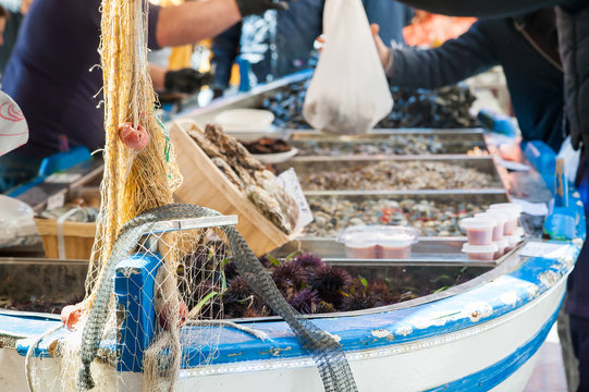 Fototapeta Close up view of a fishing net on the boat of a fish seller in the public fish market of Catania