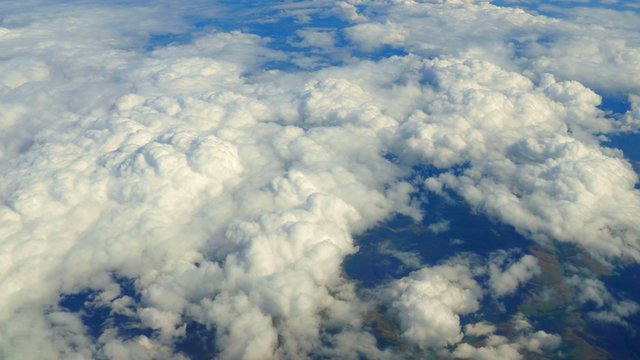 Aerial view of graceful, slow moving clouds far below.

