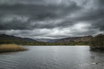 Stormy dramatic sky over Lake District countryside landscape