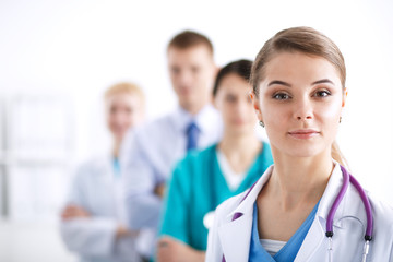 Attractive female doctor in front of medical group