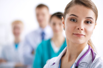 Fototapeta premium Attractive female doctor in front of medical group