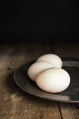 Fresh duck eggs in moody vintage retro style natural lighting se