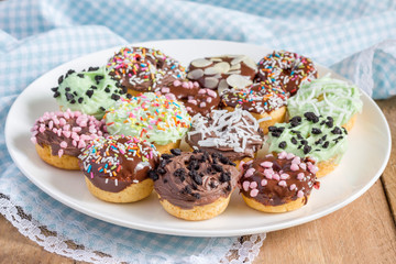 Obraz na płótnie Canvas Fresh baked homemade mini donuts on a white plate