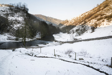 Fototapeta na wymiar Beautiful Winter snow covered countryside landscape of river flo