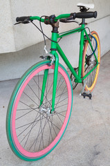 Fototapeta na wymiar green fixed gear bicycle at building