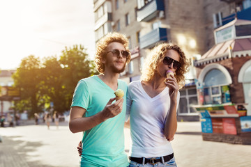 young couple walking and licking ice cream