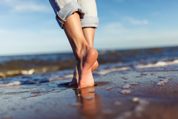 feet of woman  in the sea waves