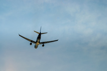 Fototapeta na wymiar airplane flying over the blue sky ,Shot from the bottom