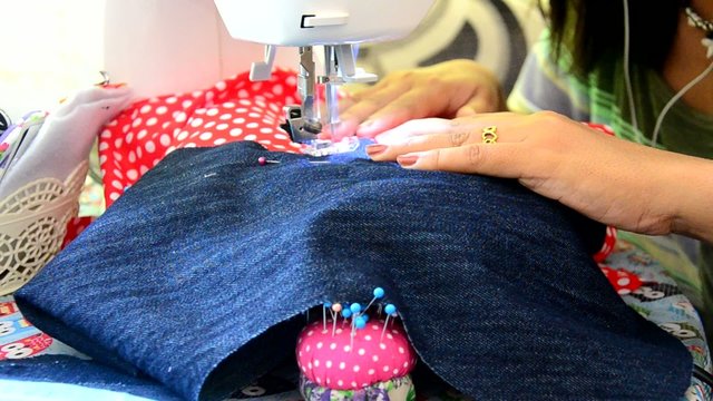 Asian women use machine sewing clothes