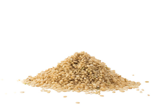 Pile of whole brown rice isolated on white