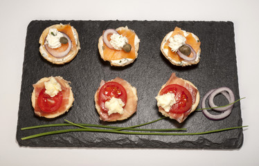 Mini sandwiches - bread with cream cheese, smoked salmon, and vegetables