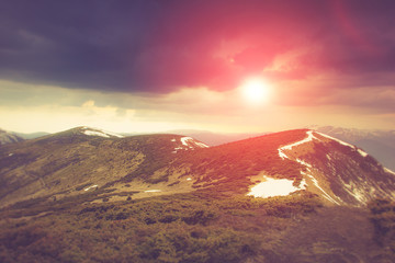 Landscape in the mountains:snowy tops and spring valleys.
