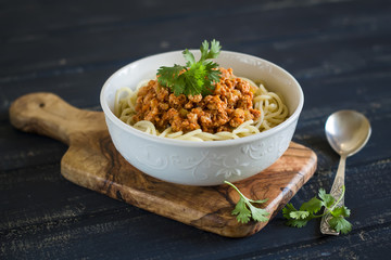pasta with meat sauce in a white bowl 
