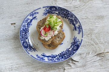 healthy toast with cottage cheese, radish, cucumber and tomatoes 