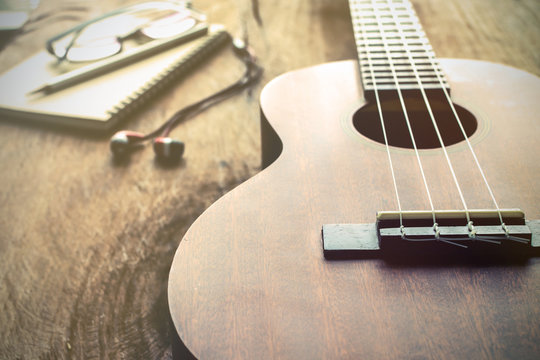 Close up of ukulele on old wood background with soft light
