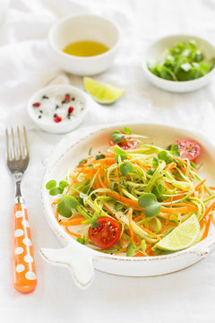 fresh salad with zucchini and carrots in a vintage plate