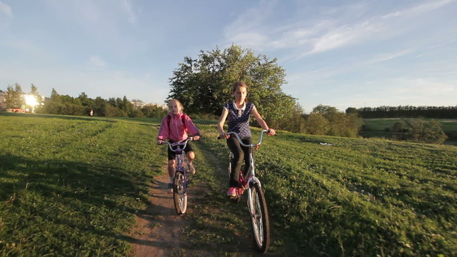 Girls riding bicycle in the countryside