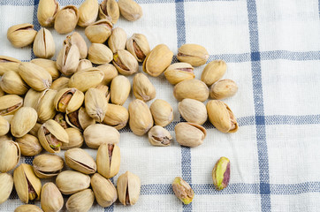 roasted and salted pistachios on table cloth