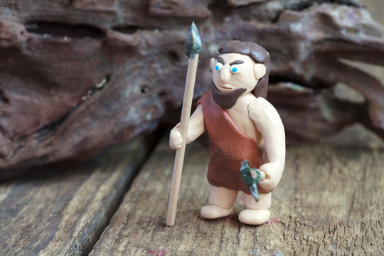 Plasticine world - the caveman in the skin with a spear and ax
