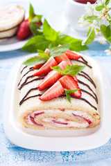 Homemade sponge roll with strawberries and mascarpone cream