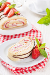 Homemade sponge roll with strawberries and mascarpone cream