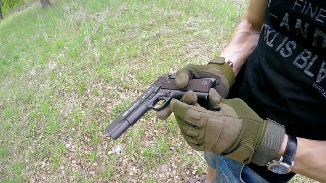 man shoots from airsoft gun outdoor