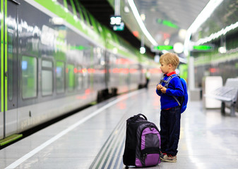 little boy waiting for the train on tube platform