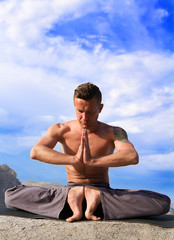 Naklejka na ściany i meble man practices yoga on the nature
