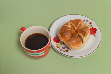 pineapple bread  on the white dish with black coffee
