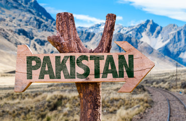 Pakistan wooden sign with desert road background