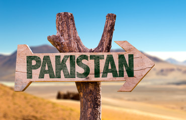 Pakistan wooden sign with desert road background