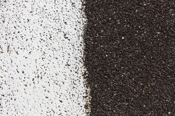 Closeup of a  asphalt pavement texture with a white line painted