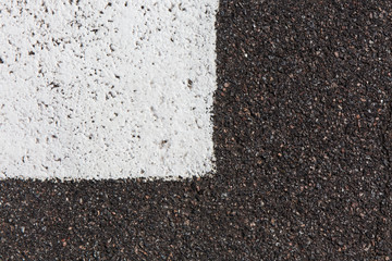 Closeup of a  asphalt pavement texture with a white line painted