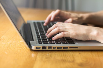 Close up hands, woman using laptop 