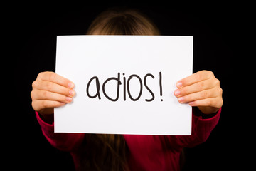 Child holding sign with Spanish word Adios - Goodbye